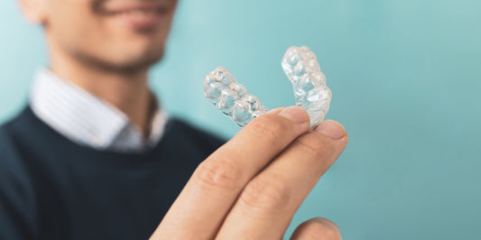 man holding a clear custom night guard